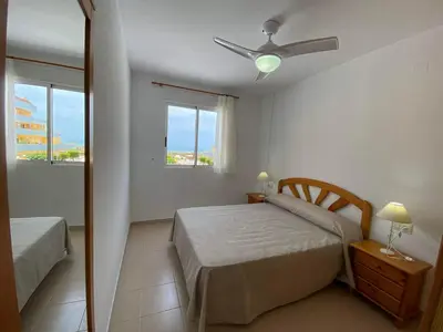 a bedroom with a bed and a ceiling fan at LAS LANZAS II - ATF Turisferr in Tavernes de Valldigna