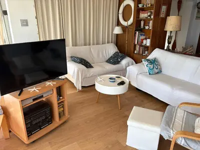 a living room with a large flat screen tv at Fantásticas vistas al mar en el Faro in Faro de Cullera