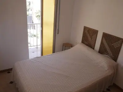 a white bed in a room with a balcony at El Raco, C-5-10 in Cullera