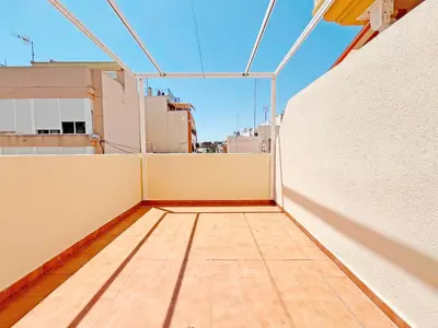 a balcony with a wooden floor on a building at Global Vacacional, Apartamento con terraza en la playa de Puerto Sagunto in Puerto de Sagunto
