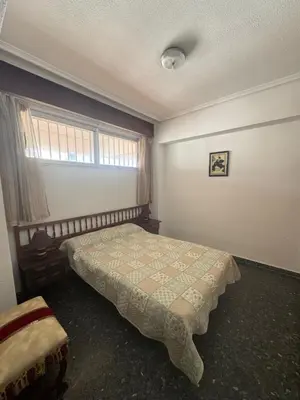 a bedroom with a bed and a window at Résidence El Prado in Cullera