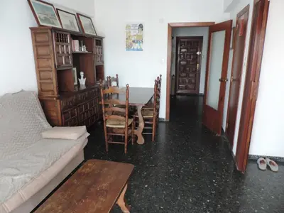 a living room with a table and a couch at Résidence El Prado in Cullera