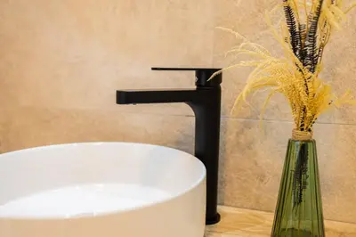 a bathroom with a sink and a vase with flowers at GuestReady - Inviting Valencia retreat in Valencia