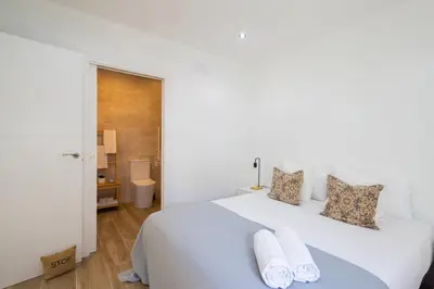 a white bedroom with a large white bed with two pillows at GuestReady - Inviting Valencia retreat in Valencia