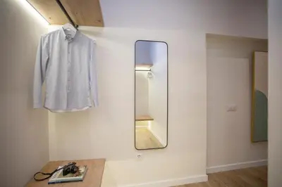 a mirror hanging on a wall next to a sink at Nomad Haux Zaidia in Valencia
