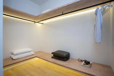 a room with a bed and a suitcase on the floor at Nomad Haux Zaidia in Valencia
