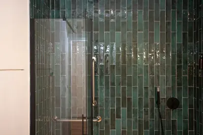 a shower with green and glass tiles in a bathroom at Nomad Haux Zaidia in Valencia