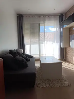 a living room with a couch and a coffee table at Puzol beach penthouse in Playa de Mar