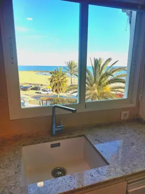 a kitchen sink with a view of the beach from a window at ESPECIAL FALLAS 25 MINUTOS VALENCIA PLAYA in Puerto de Sagunto
