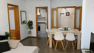 a kitchen and dining room with a table and chairs at ESPECIAL FALLAS 25 MINUTOS VALENCIA 6 PLAZAS in Puerto de Sagunto