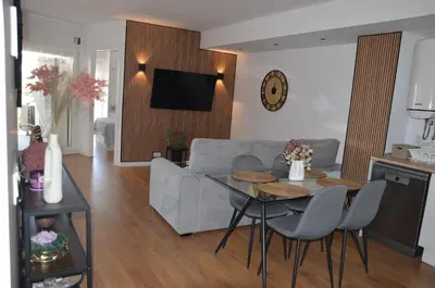 a living room with a couch and a table with chairs at Fabuloso Piso Playa Canet de Bereguer Alquiler minimo 11 noches llamar al 64039uno856 in Canet de Berenguer