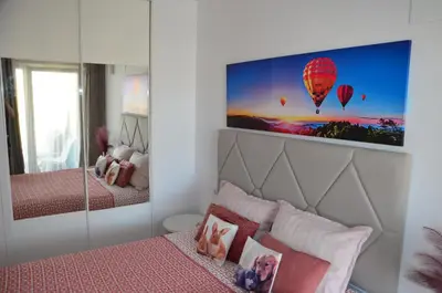 a bedroom with a bed and a picture of a hot air balloon at Fabuloso Piso Playa Canet de Bereguer Alquiler minimo 11 noches llamar al 64039uno856 in Canet de Berenguer