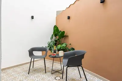 two chairs and a table in a room with plants at SariStays Valencia City Center L in Valencia