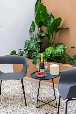 a table with two chairs and wine glasses on it at SariStays Valencia City Center L in Valencia