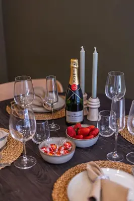a table with glasses and a bottle of wine and strawberries at SariStays Valencia City Center R in Valencia