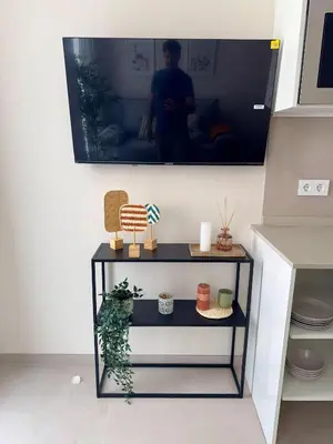 a living room with a table with a tv on the wall at Apartamento Boutique Valencia 4-Pax - B-2 in Valencia