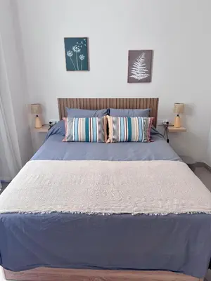 a bedroom with a bed with blue sheets and pillows at Apartamento Boutique Valencia 4-Pax - C-3 in Valencia