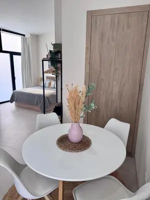 a white table with white chairs and a vase on it at Apartamento Boutique Valencia 4-Pax - C-3 in Valencia