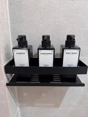two bottles of soap on a shelf in a bathroom at Apartamento Boutique Valencia 4-Pax - C-3 in Valencia