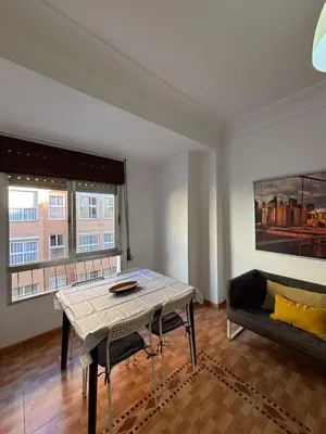 a living room with a table and a couch at The Ruzafa by Laura - AVE in Valencia