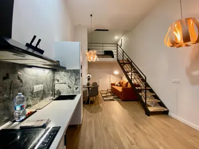 a kitchen with a staircase and a living room at Duplex City of Arts & Science in Valencia