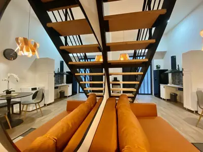 a spiral staircase in a living room with a couch at Duplex City of Arts & Science in Valencia