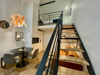 a staircase leading up to a room with a table at Duplex City of Arts & Science in Valencia