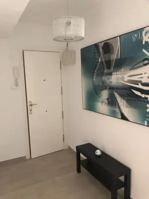 a room with a black table and a picture on the wall at Apartamento con vistas a la playa in El Perelló