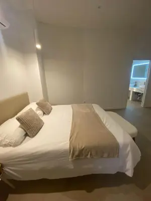 a white bed in a room with a window at Room Turia in Valencia