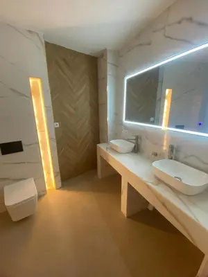 a bathroom with two sinks and a mirror at Room Turia in Valencia