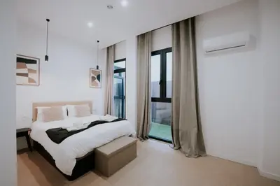 a white bedroom with a bed and a window at Room Turia in Valencia
