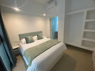 a bedroom with a large white bed with two pillows at Room Turia in Valencia