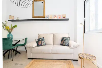 a living room with a white couch and a table at Casa Ambrosia in Valencia