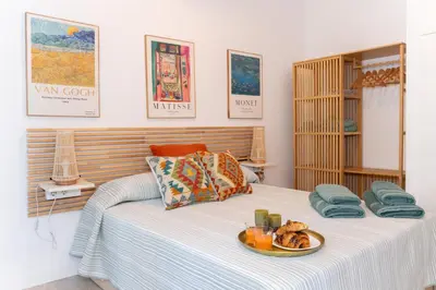a bedroom with a bed with a plate of food on it at Casa Ambrosia in Valencia