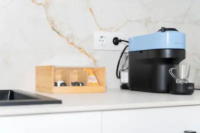 a kitchen counter with a coffee maker and a wooden box at Casa Ambrosia in Valencia