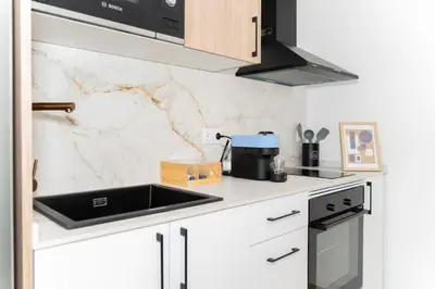 a white kitchen with a sink and a stove at Casa Ambrosia in Valencia