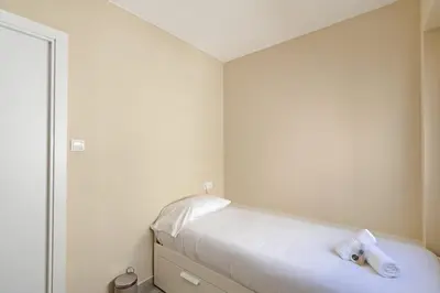 a living room with a table and chairs and a tv at GuestReady - Your Relaxing Base in Valencia in Valencia
