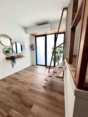 a living room with a staircase and mirrors at Aires de Valencia in Valencia