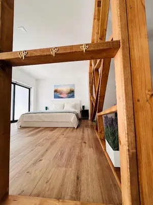 a bedroom with a bed and a wooden floor at Aires de Valencia in Valencia