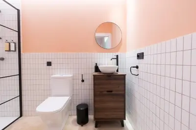 a bathroom with a toilet and a sink and a mirror at Blue City Apartments in Valencia