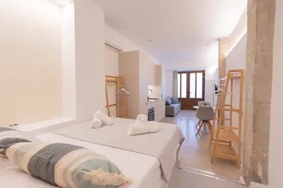 a bedroom with two beds and a living room at Blue City Apartments in Valencia