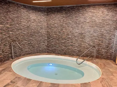 a jacuzzi tub in a room with a brick wall at Luxury Canet in Canet de Berenguer