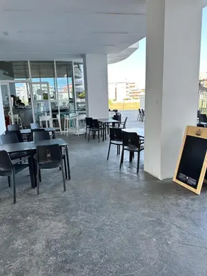 a room with tables and chairs and a tv at Luxury Canet in Canet de Berenguer