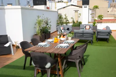 a wooden table and chairs on a rooftop patio at SingularStays Mar44 Terrace in Valencia