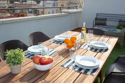 a wooden table with a bowl of fruit on it at SingularStays Mar44 Terrace in Valencia