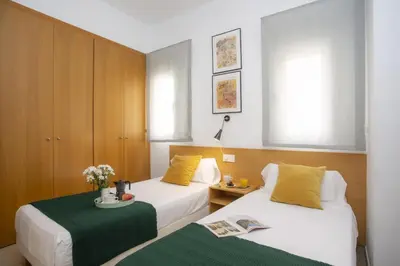 a hotel room with two beds and a table at SingularStays Mar44 Terrace in Valencia