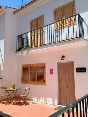 a balcony of a house with a table and chairs at Casa Numari in Caudiel