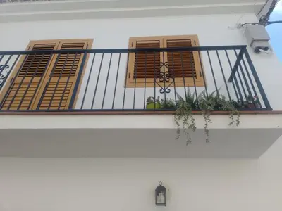 a balcony with windows and plants on a white building at Casa Numari in Caudiel