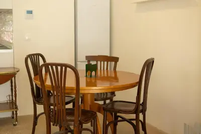 a wooden table with four chairs around it at Apartamento para 4 huespedes con Patio y ducha Exterior in Valencia