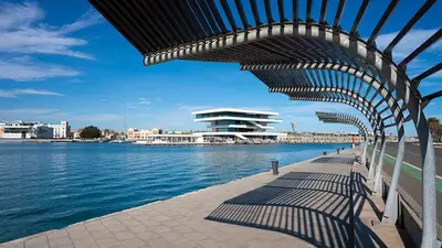a building with awning over a body of water at Apartamento para 4 huespedes con Patio y ducha Exterior in Valencia